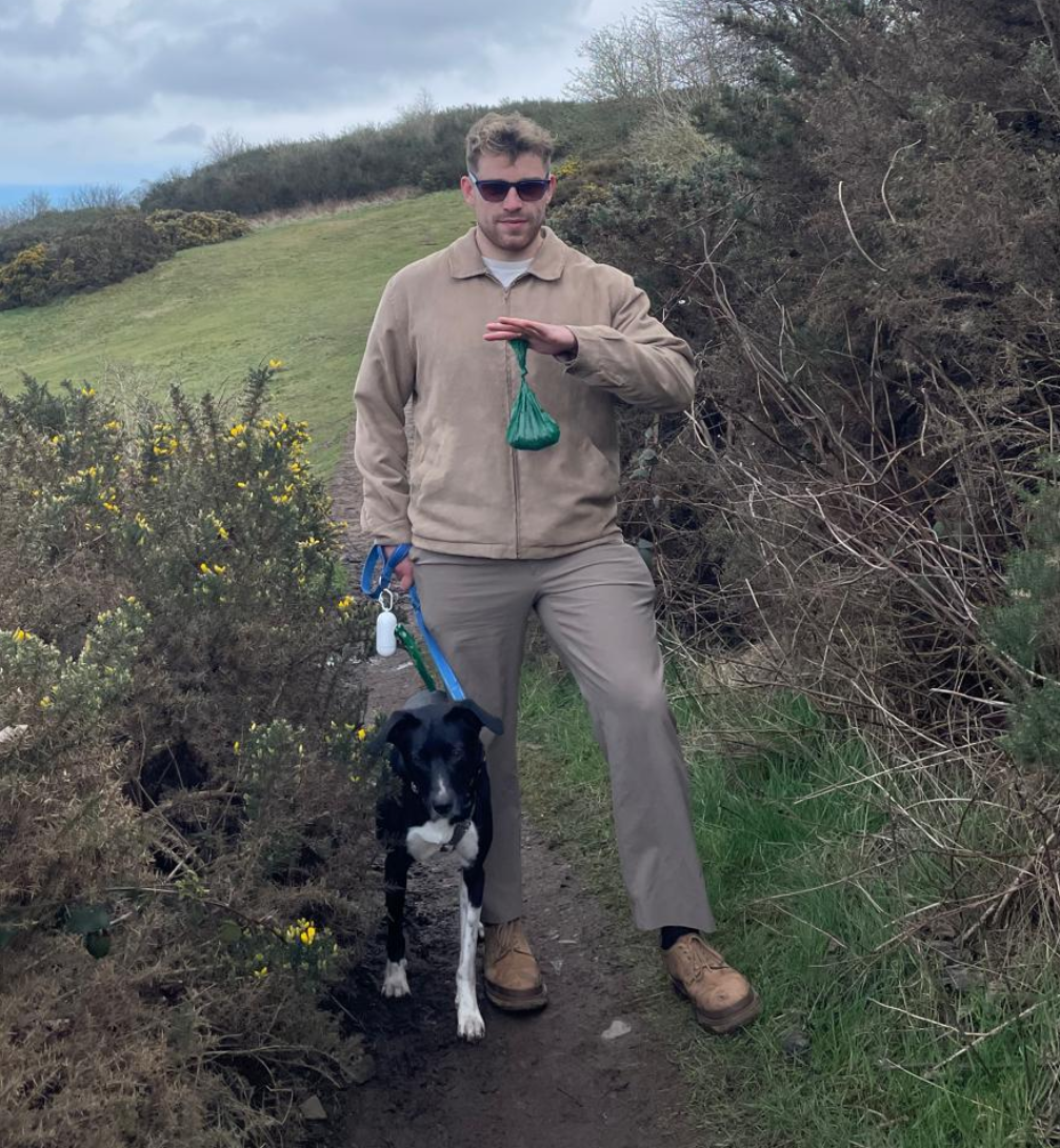 Nick hiking with black dog